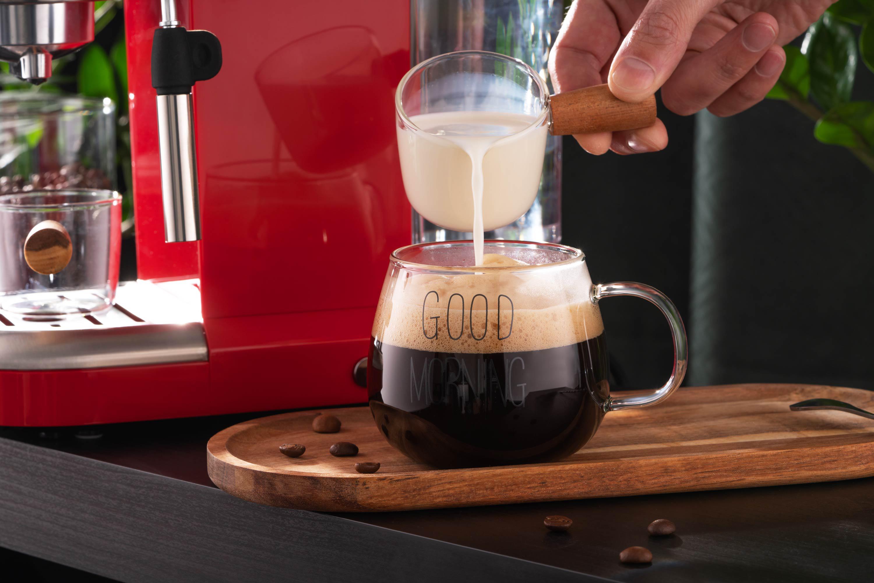 Емкость для сливок из боросиликатного стекла 100 мл с деревянной ручкой на фоне кофемашины