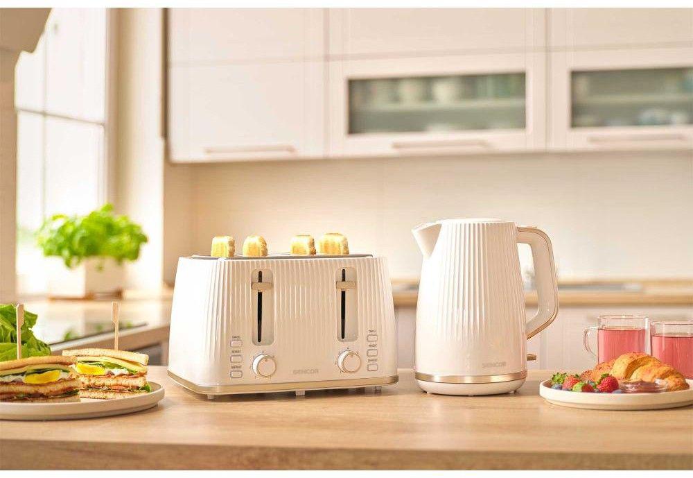 Тостер Sencor STS7540WH у світлій кухні з булочками на решітці та сніданком поруч